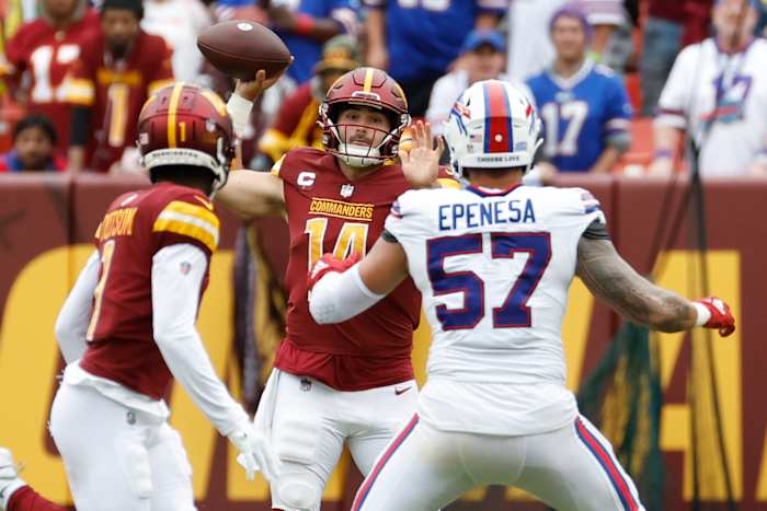 Washington Commanders quarterback Sam Howell (14) attempts to pass the ball to Commanders wide receiver Jahan Dotson (1) as Buffalo Bills defensive end AJ Epenesa (57) defends during the fourth quarter at FedExField.